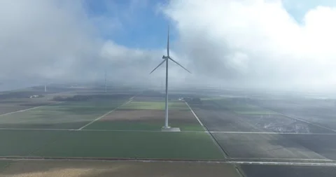 Wind turbines surrounded by low hanging clouds, aerial views. The Netherlands. Видео 305158606