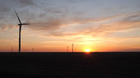 Wind turbines on a Texas farm at sunrise Stock Footage