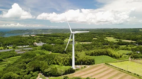 Wind Turbines Turning Under a Blue Sky Stock Footage 335571187
