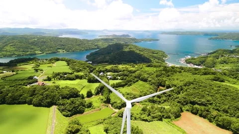 Wind Turbines Turning Under a Blue Sky Stock Footage 335571975