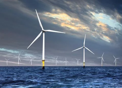 Wind turbines under cloud sky Stock Photos