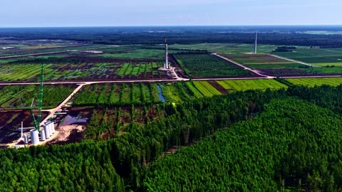 Wind turbines under development in rural Latvia Wide Aerial 스톡 동영상 330868421