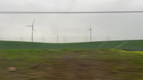 Wind turbines viewed from high speed train TGV in France Stock Footage 242367930