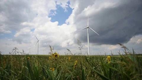 Wind turbines in a wind farm with a dramatic stormy sky in the background 스톡 동영상 112341989