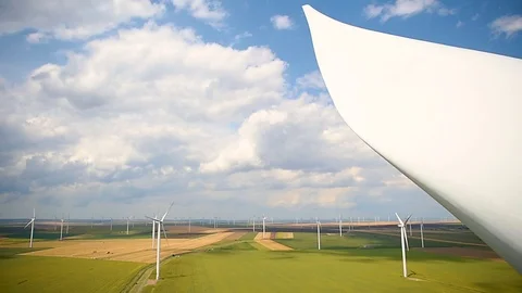 Wind turbines in a wind farm with a dramatic stormy sky in the background 스톡 동영상 112342247