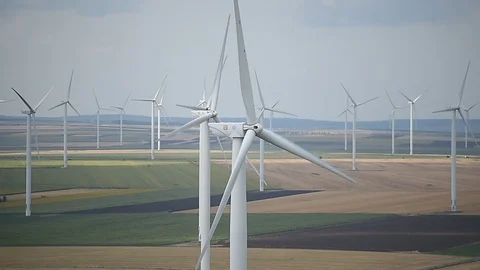 Wind turbines in a wind farm with a dramatic stormy sky in the background Video stock 113407968