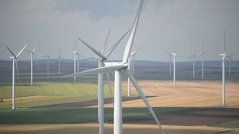 Wind turbines in a wind farm with a dramatic stormy sky in the background Video stock 113408195