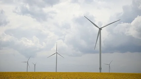 Wind turbines in a wind farm with a dramatic stormy sky in the background Video stock 113408288