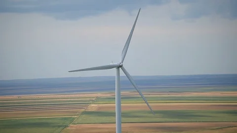 Wind turbines in a wind farm with a dramatic stormy sky in the background Video stock 113408298