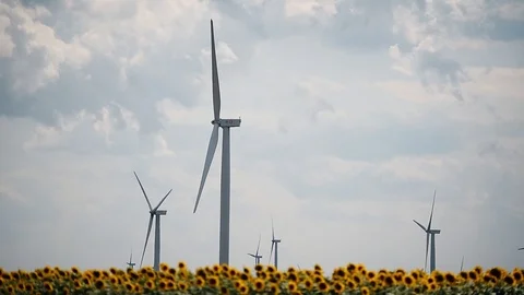Wind turbines in a wind farm with a dramatic stormy sky in the background Video stock 113408410
