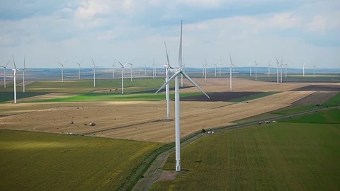 Wind turbines in a wind farm with a dramatic stormy sky in the background Video stock 113408460