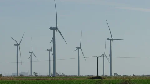 Wind turbines on a wind farm generating power, in slow motion Stock Footage 98015173