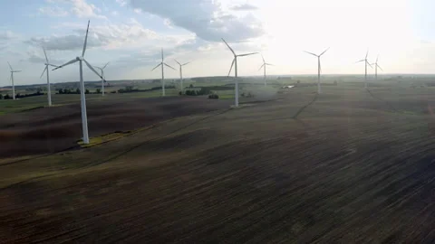 Wind Turbines In A Wind Farm Generating Clean Green Energy On Open Grass Field Stock Footage 138441947