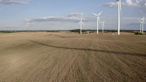 Wind Turbines In A Wind Farm Generating Clean Green Energy On Open Grass Field Stock Footage 138442011