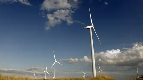 Wind Turbines In A Wind Farm Generating Clean Green Energy On Open Grass Field Stock Footage 138442144