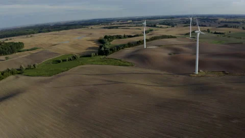 Wind Turbines In A Wind Farm Generating Clean Green Energy On Open Grass Field Stock Footage 138442478