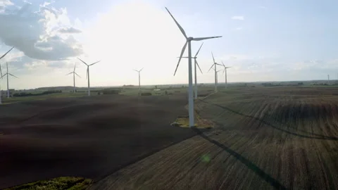 Wind Turbines In A Wind Farm Generating Clean Green Energy On Open Grass Field Stock Footage 138442556