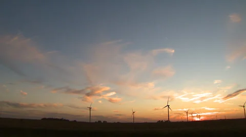 Wind Turbines on Wind Farm Pan across during sunset Stock Footage 32936087