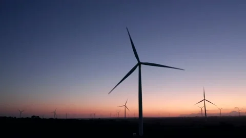 Wind Turbines on a wind farm at sunset, aerial drone tracking shot  Stock Footage 140826774