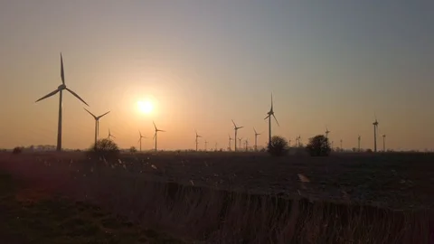 Wind turbines in windpark at sundown Video stock 128228379