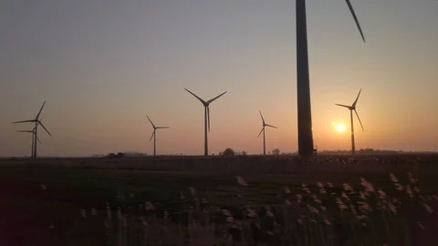 Wind turbines in windpark at sundown Video stock 128229090