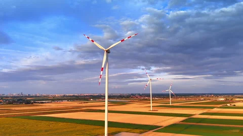 Wind turbines working in agricultural fields under cloudy sky. High view of Stock Footage 339016428