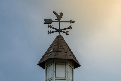 A wind vane on display with a stunning sky backdrop and rays of sunlight sh.. Stock Photos