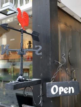 Wind vane rooster with open sign 写真素材