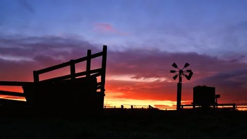 Wind Water Pump And Loading Ramp Silhouette Stock Photos