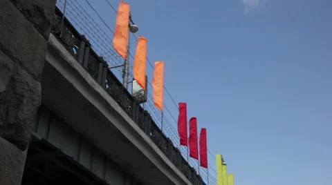 Wind waving flags on the bridge Stock Footage 5318354