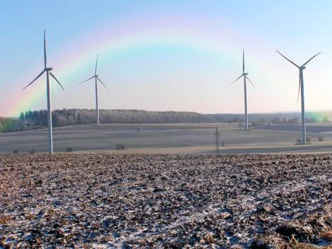 Wind wheels with rainbow Stock Photos