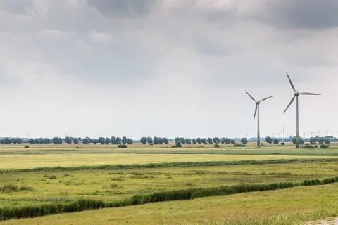 Wind wheels for renewble energy on the flat marshland of North Germany Stock Photos