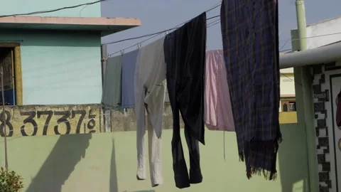 Wind-Whipped Laundry - A City Street's Colorful Daily Dance 스톡 동영상 318488371