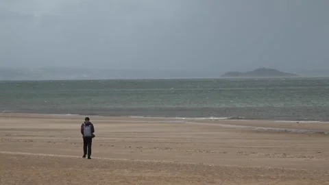 Wind whips up sand on Edinburgh beach as Storm Floris hits the UK Stock Footage 314270872