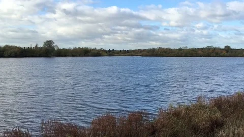 Windblown Deep Blue Lake on a windy yet sunny day in sunshine 库存影片 72634957