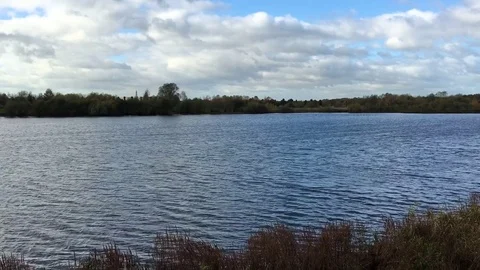 Windblown Deep Blue Lake on a windy yet sunny day in sunshine 動画素材 72634958