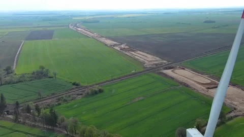 Windbreaks and Bridge Construction Over Green Fields Video stock 297077152