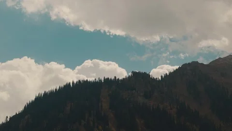 Winde agle view of clouds moving behind a moutain in alpine region of Pakistan Video stock 330441437