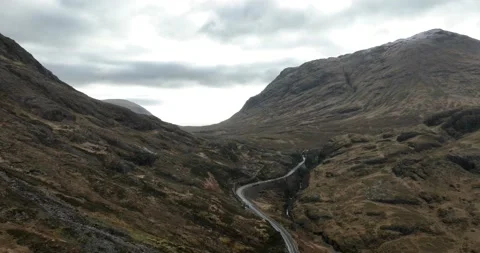 Winding A82 road up through Glencoe valley at sunrise Stockbeeldmateriaal 233975861
