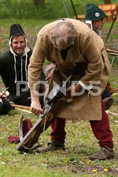 Winding back the tension on a medieval crossbow Stock Photos