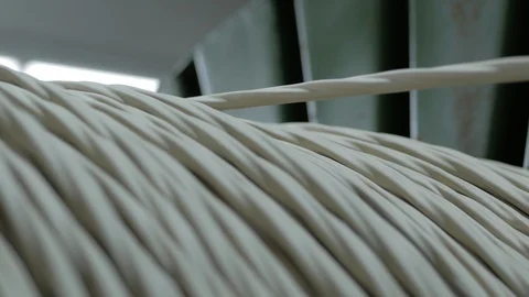Winding cable on a rotating coil. Production of electric cable. Stock Footage 125257302