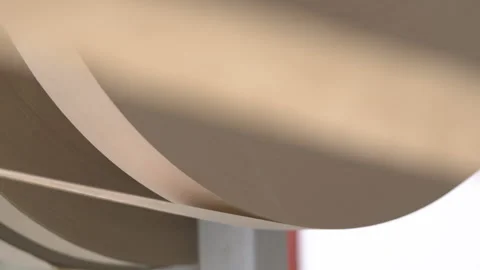 Winding cardboard web onto large cylindrical object Stockbeeldmateriaal 295151870