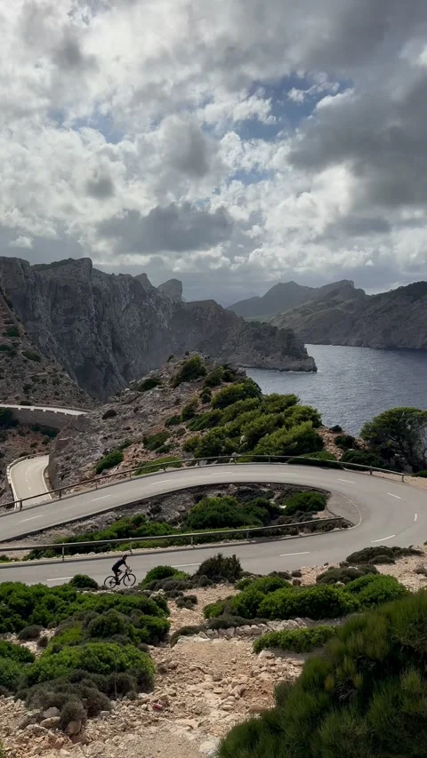 Winding coastal serpentine road with dramatic sea and mountain view Video stock 318092572