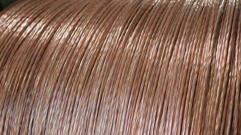 Winding a copper cable on a rotating coil. Production of electric cable. Stock Footage 123918092