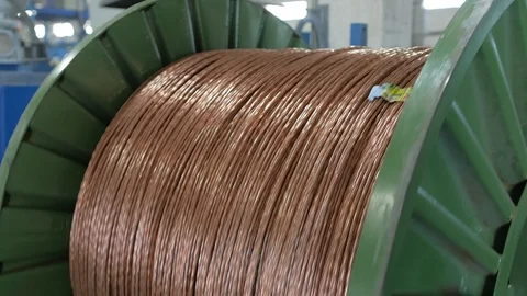Winding a copper cable on a rotating coil. Production of electric cable. Stock Footage 123920818