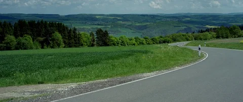 A winding country road with rape fields, Germany, July 2018 Stock Footage 100567140