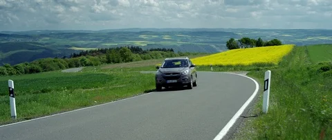 A winding country road with rape fields, Germany, July 2018 Stock Footage 100567737