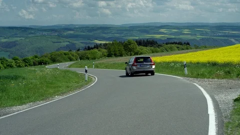 A winding country road with rape fields, Germany, July 2018 Video stock 100568490
