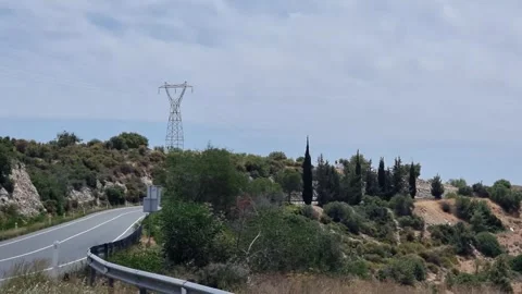 Winding Cyprus road through hillside with cypress trees and power line Stock Footage 328095242