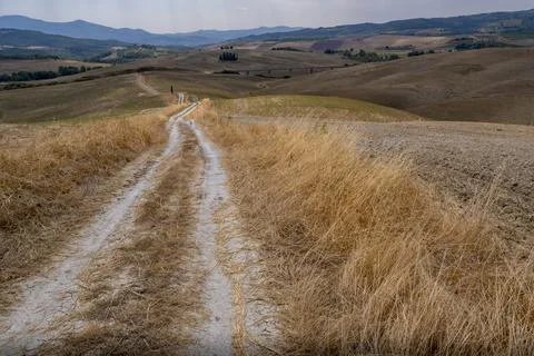 Winding Dirt Path through Dry Hills and Scenic Valley Stock Photos